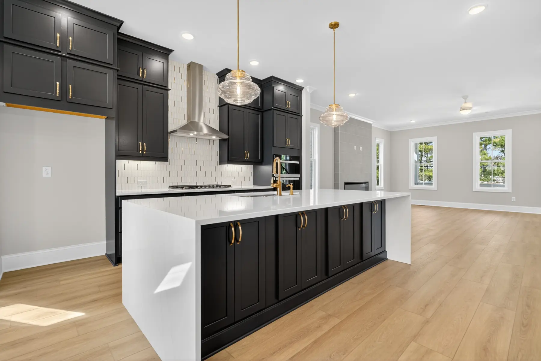 Black cabinetry and brass detail kitchen photographed by Archetype Visuals